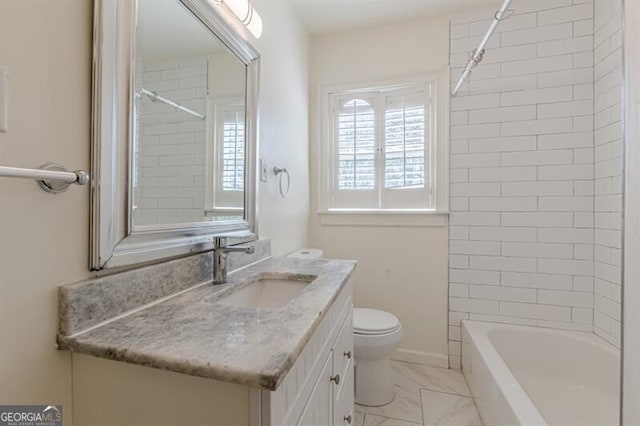 bathroom with toilet, vanity, marble finish flooring, and tub / shower combination