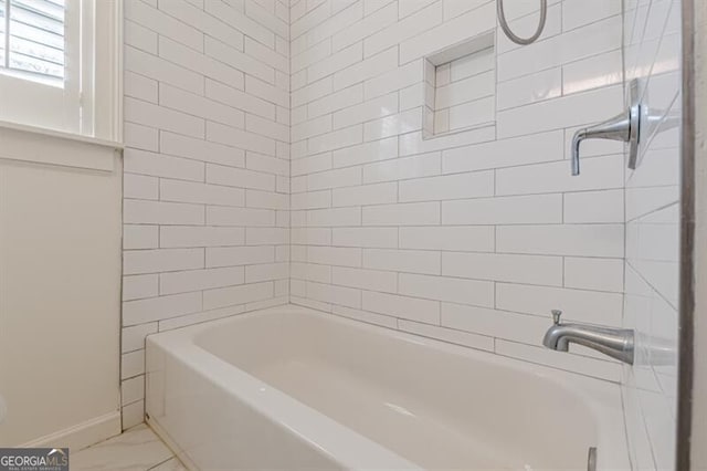 full bathroom featuring baseboards, marble finish floors, and shower / washtub combination