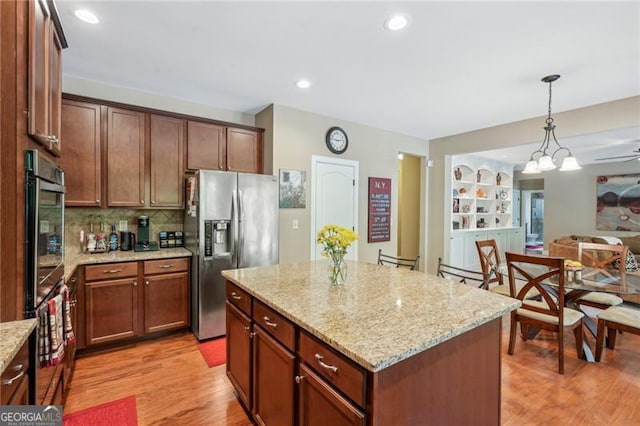 6565 Bentley Ridge Dr, Cumming, GA 30040 - kitchen with stainless steel appliances, hanging light fixtures, light wood-type flooring, light stone countertops, and recessed lighting