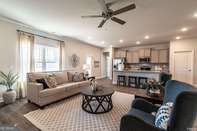 living area featuring recessed lighting, a ceiling fan, baseboards, and dark wood-style flooring