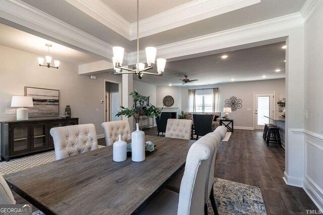 dining space featuring ceiling fan with notable chandelier, dark wood-style floors, recessed lighting, and ornamental molding