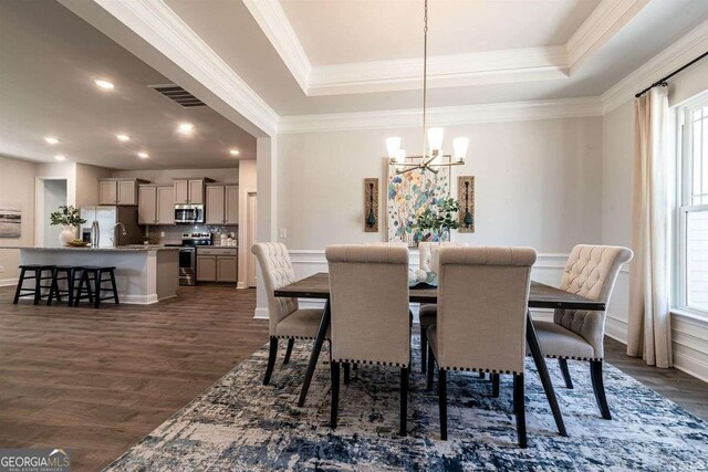 dining space featuring a wealth of natural light, dark wood finished floors, visible vents, a chandelier, and ornamental molding