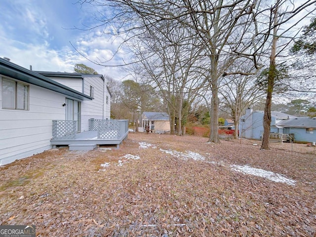 view of yard with a wooden deck and an outdoor structure