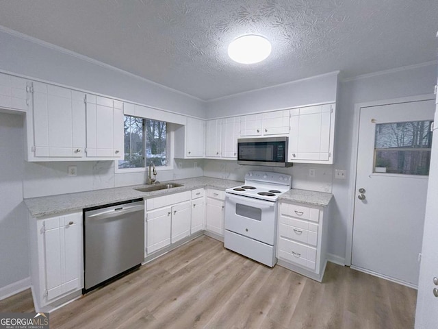 kitchen featuring white cabinets, appliances with stainless steel finishes, a sink, and a textured ceiling