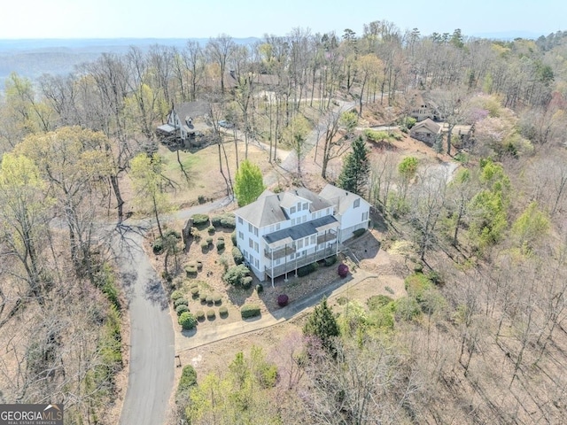 aerial view featuring a wooded view