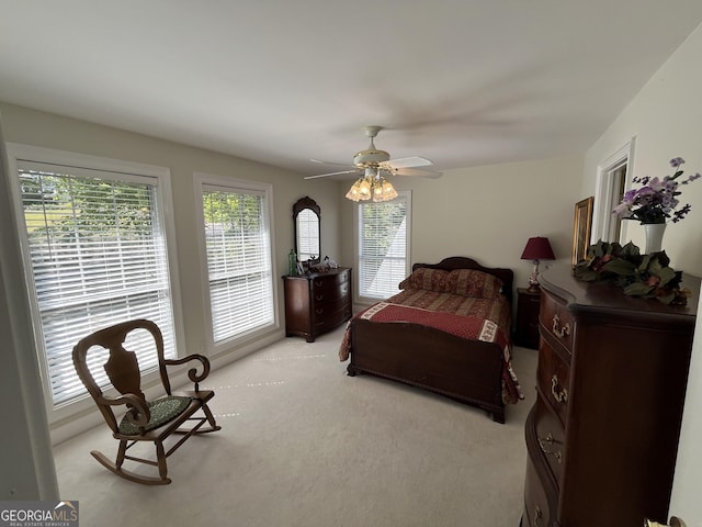 bedroom featuring light carpet and ceiling fan