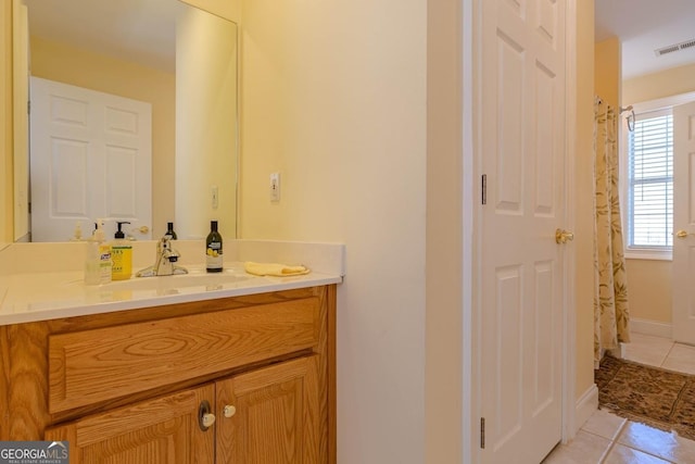 full bath featuring tile patterned floors, vanity, curtained shower, baseboards, and visible vents