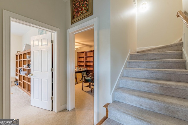 stairs featuring carpet floors and baseboards