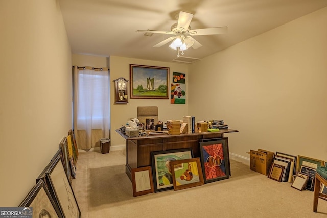 carpeted office featuring a ceiling fan and baseboards