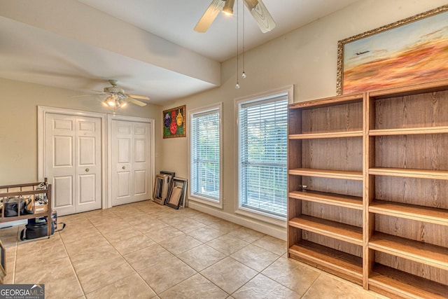 interior space with ceiling fan and light tile patterned floors