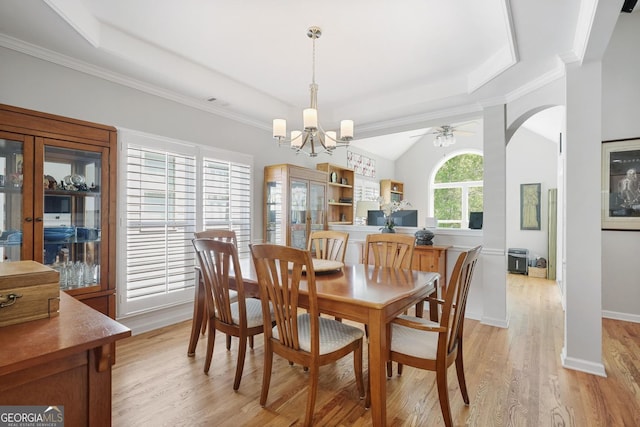 123 Heritage Pointe, Woodstock, GA 30189 - dining area featuring light wood finished floors, a chandelier, a raised ceiling, arched walkways, and a ceiling fan