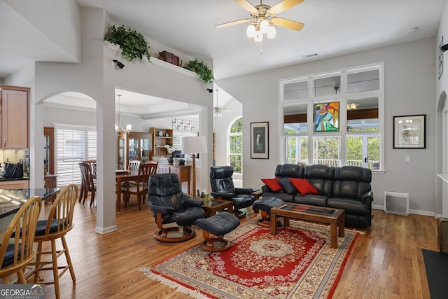 123 Heritage Pointe, Woodstock, GA 30189 - living room with ceiling fan, arched walkways, and plenty of natural light