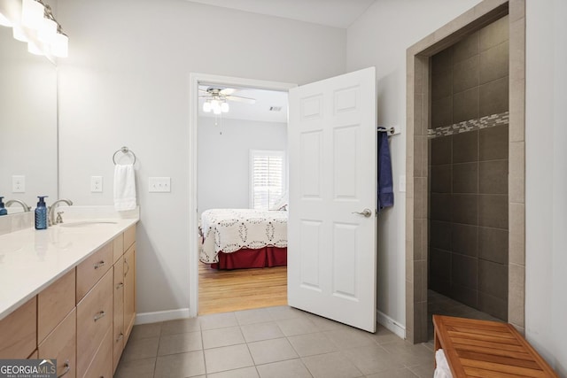 123 Heritage Pointe, Woodstock, GA 30189 - bathroom featuring tile patterned flooring, ceiling fan, vanity, ensuite bath, and baseboards