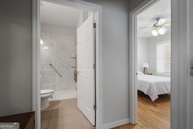 123 Heritage Pointe, Woodstock, GA 30189 - ensuite bathroom featuring toilet, a stall shower, ceiling fan, and tile patterned floors