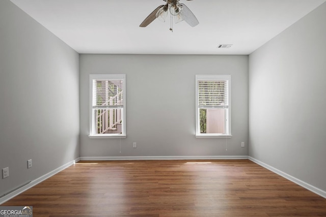 123 Heritage Pointe, Woodstock, GA 30189 - spare room with a ceiling fan, wood finished floors, and baseboards