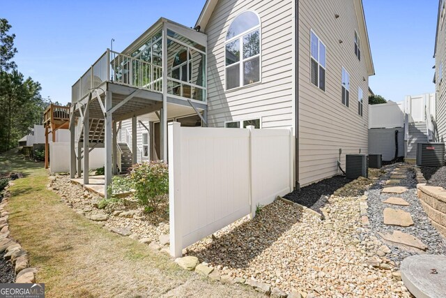 123 Heritage Pointe, Woodstock, GA 30189 - view of side of home with stairway, central air condition unit, a deck, and fence