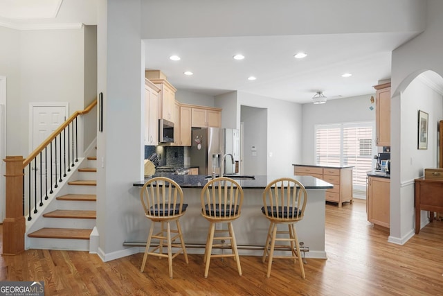123 Heritage Pointe, Woodstock, GA 30189 - kitchen with appliances with stainless steel finishes, a peninsula, dark countertops, light wood finished floors, and recessed lighting