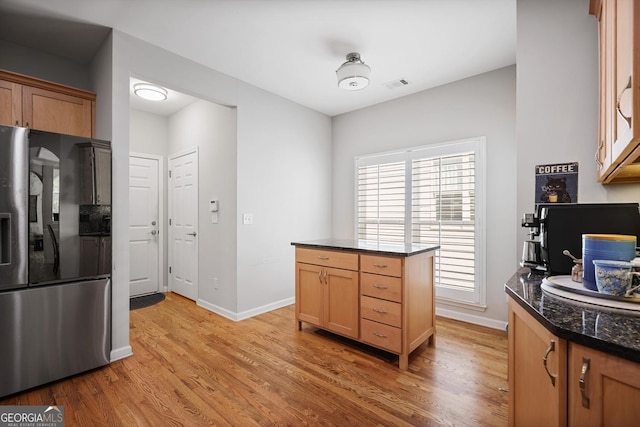 123 Heritage Pointe, Woodstock, GA 30189 - kitchen with stainless steel fridge, light wood-style floors, and dark stone countertops
