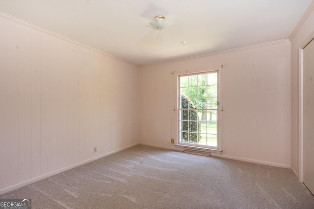 carpeted empty room with baseboards and ornamental molding
