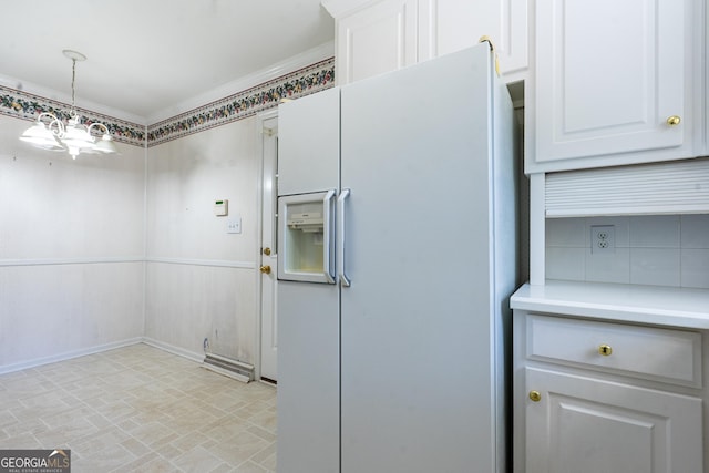 kitchen with white cabinets, pendant lighting, white fridge with ice dispenser, and light countertops