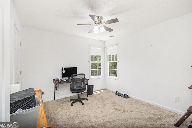 office space with carpet, ceiling fan, and baseboards
