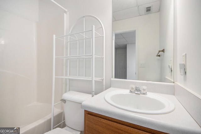 full bathroom with a paneled ceiling, vanity, toilet, and bathtub / shower combination