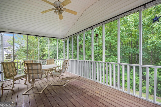 sunroom with outdoor dining space, ceiling fan, and vaulted ceiling