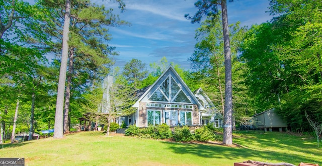 rear view of house with a lawn