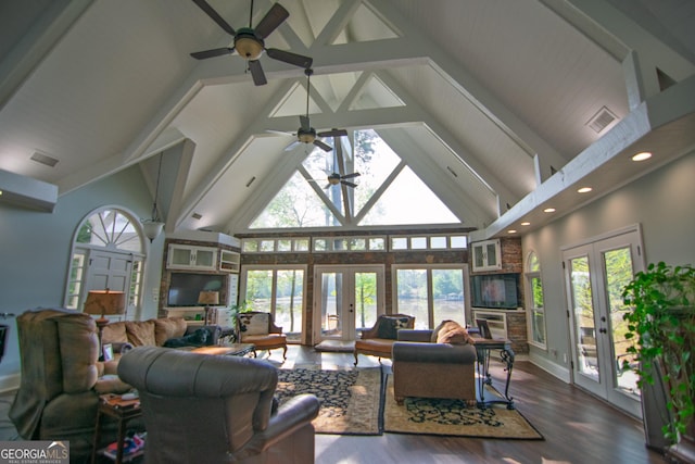living room with plenty of natural light, french doors, high vaulted ceiling, and ceiling fan