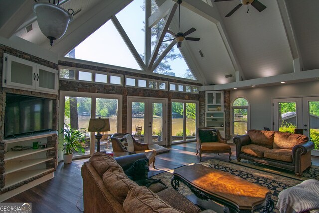 living area featuring a ceiling fan, french doors, dark wood-type flooring, beam ceiling, and high vaulted ceiling