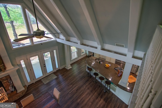 entryway with high vaulted ceiling, wood finished floors, ceiling fan, beam ceiling, and visible vents