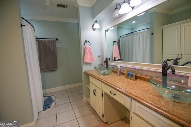 bathroom with visible vents, crown molding, and a sink