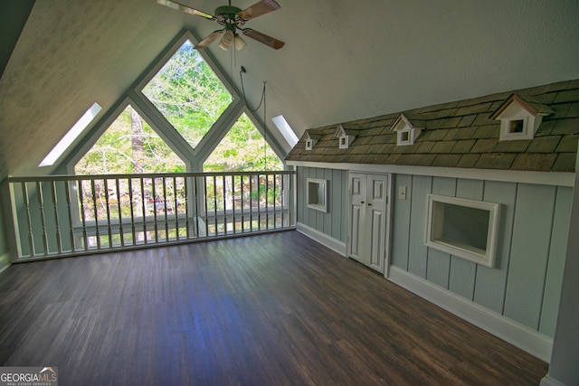 additional living space with lofted ceiling, wood finished floors, a ceiling fan, and baseboards
