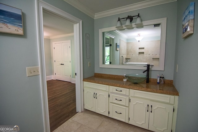 full bathroom featuring wood finished floors, vanity, a tile shower, and crown molding