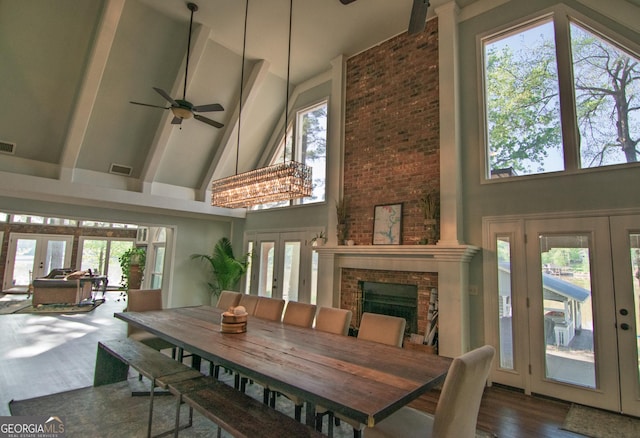 sunroom / solarium featuring visible vents, a wealth of natural light, and french doors