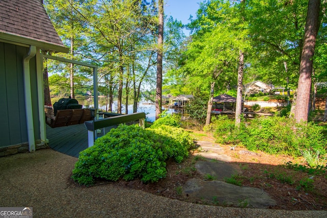 view of yard featuring a deck with water view