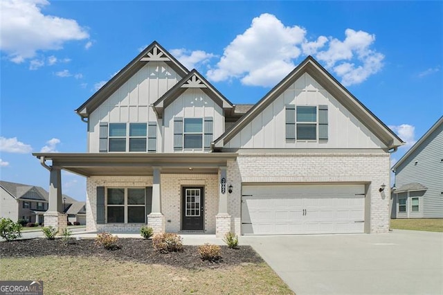 craftsman-style house featuring board and batten siding, brick siding, a porch, and driveway