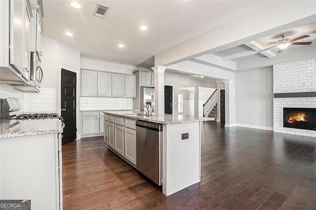 kitchen featuring open floor plan, ceiling fan, appliances with stainless steel finishes, visible vents, and recessed lighting