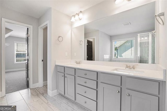 full bath with baseboards, a sink, visible vents, and double vanity