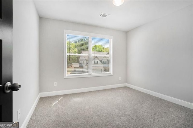 carpeted empty room with baseboards and visible vents