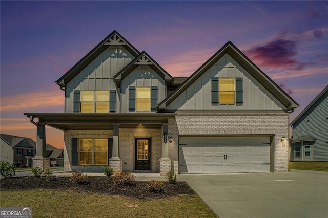 craftsman-style house featuring board and batten siding, brick siding, concrete driveway, and covered porch