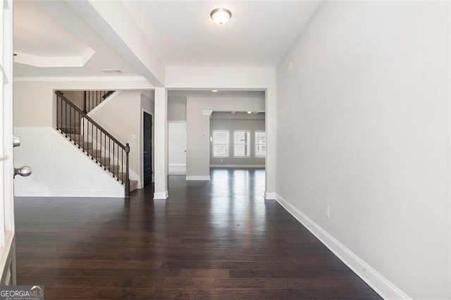 interior space with baseboards, wood finished floors, and stairway