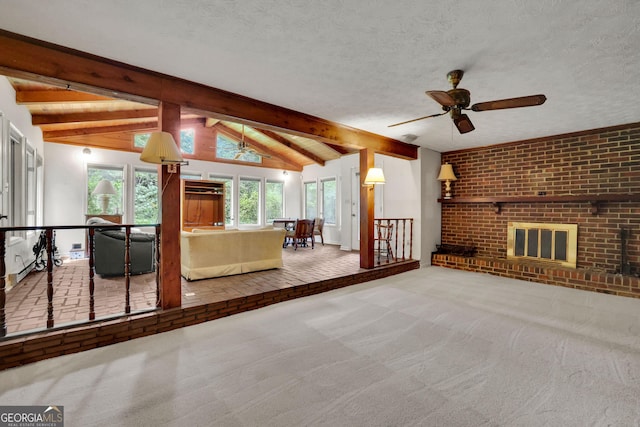 living room featuring carpet, ceiling fan, a fireplace, and a textured ceiling