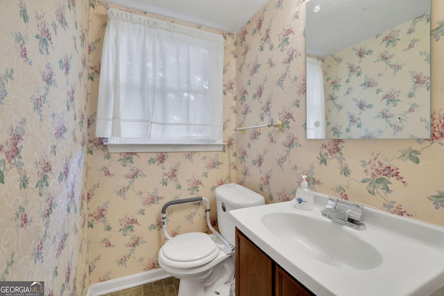 bathroom with vanity, baseboards, toilet, and tile patterned flooring