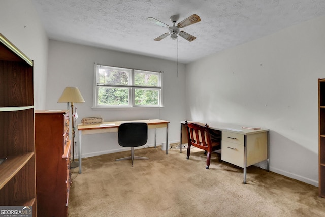 office area with carpet, ceiling fan, baseboards, and a textured ceiling