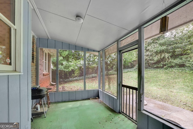 unfurnished sunroom with lofted ceiling