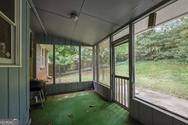 unfurnished sunroom with vaulted ceiling