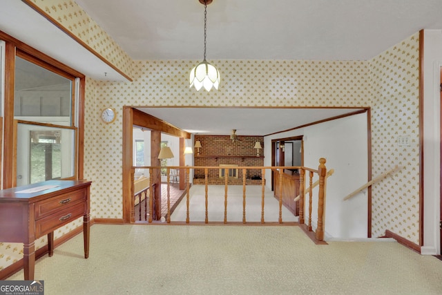 corridor with wallpapered walls, baseboards, and a chandelier