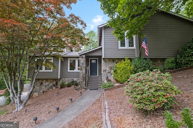 split level home featuring stone siding