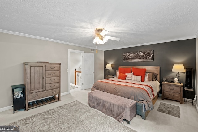 bedroom featuring a textured ceiling, visible vents, crown molding, and carpet